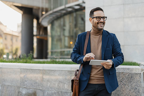 istock Smiling man with tablet in urban environment 2206862816
