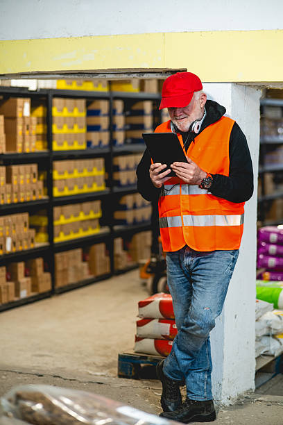istock An elderly worker in a pet food warehouse cheerfully does his job. 2206863963