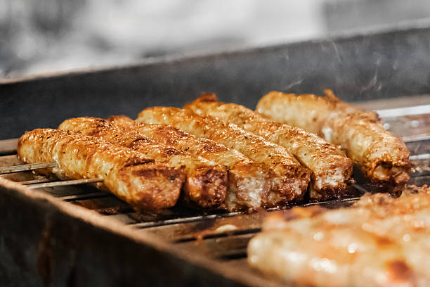 Grilled sausages cooking on outdoor barbecue