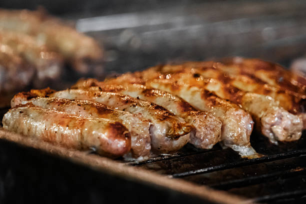 istock Grilled sausages cooking on outdoor barbecue 2206865713