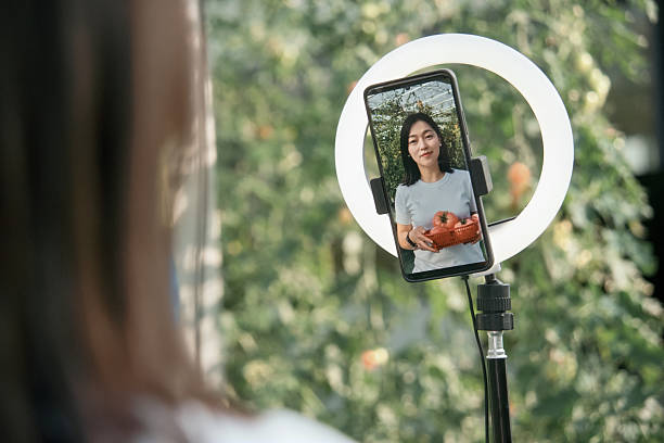 istock Asian female farmer is live-streaming on her mobile phone 2206866376