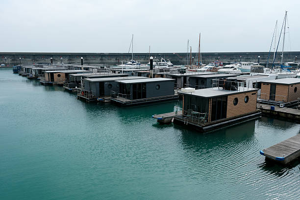 Tiny homes, house boats and Boats and Yachts moored in Brighton Marina on the south coast of England 23 March 2025 - Brighton, UK - Tiny homes, house boats and Boats and Yachts moored in Brighton Marina on the south coast of England small houseboats stock pictures, royalty-free photos & images