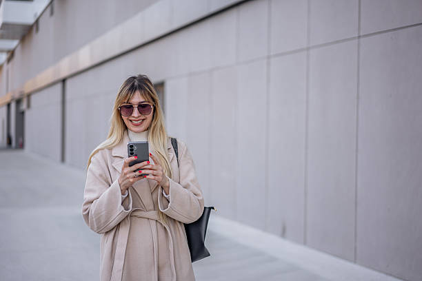 istock Young woman using phone in the city 2206869556