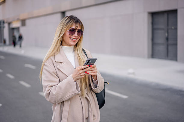 istock Young woman using phone in the city 2206869575