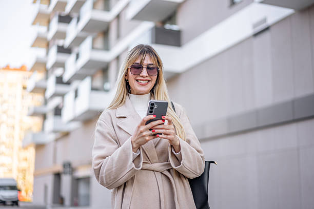 istock Young woman using phone in the city 2206869652