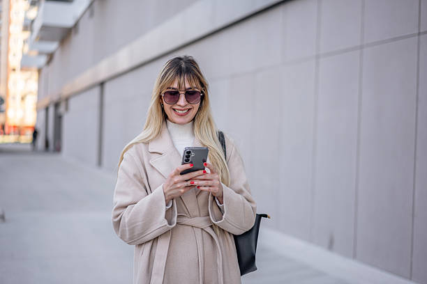 istock Young woman using phone in the city 2206870205