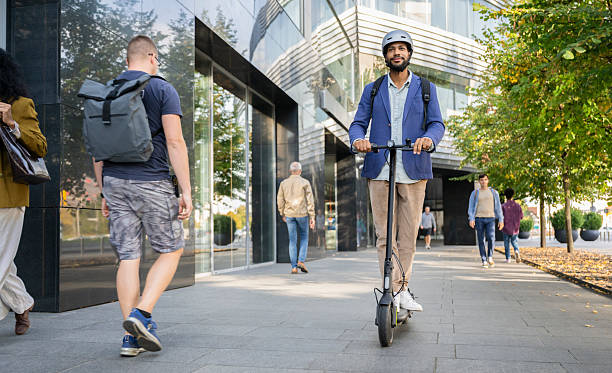 istock Well-dressed Man Riding Electric Scooter 2206870308