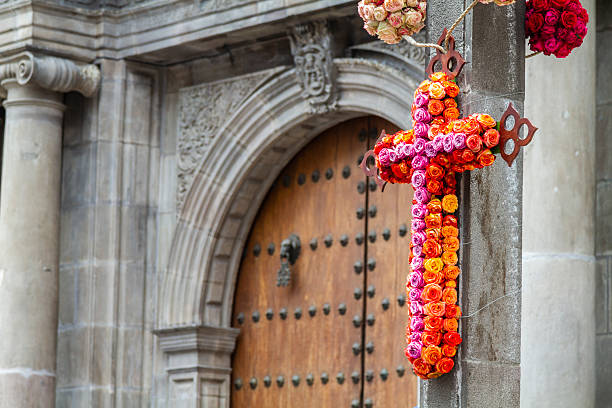 Vibrant floral cross, crafted with colorful roses, decorates a church in Quito, Ecuador, during the Holy Week celebrations, symbolizing faith and tradition