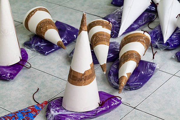 Cucuruchos and purple cloths are lying on the floor, ready for the procession of the Christ of the Great Power in Quito, Ecuador, during Holy Week