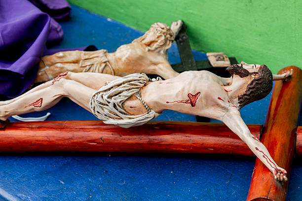 Two wooden statues of Jesus Christ on the cross, representing the crucifixion, displayed during Holy Week in Quito, Ecuador, a symbol of faith and devotion