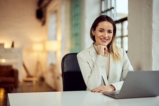 istock Smiling Professional Woman Working on Laptop in Modern Home Office Setting 2206871039