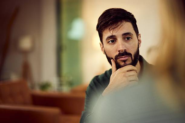 Man in Thoughtful Conversation in a Warm and Casual Environment