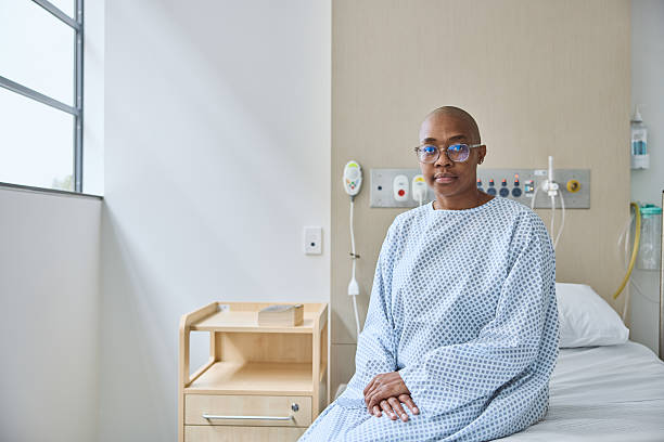 istock Woman suffering from cancer sitting on bed 2206871936