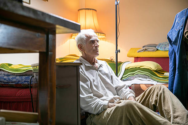 istock Senior Man Sitting on the Floor in His Room 2206873714