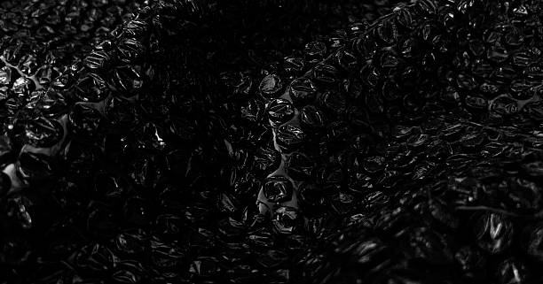 istock Black bubble pack with light reflections. Textured background photo. With intricate details for banner, poster and website background. 2206874096
