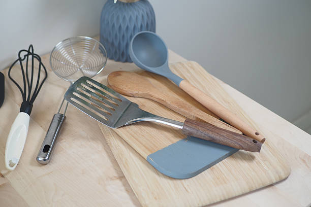 istock A Variety of Assorted Kitchen Utensils Arranged on a Wooden Cutting Board 2206874433