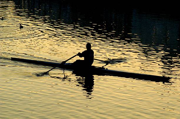 istock Silhouette of a kayaker on a golden river at sunset. 2206874528