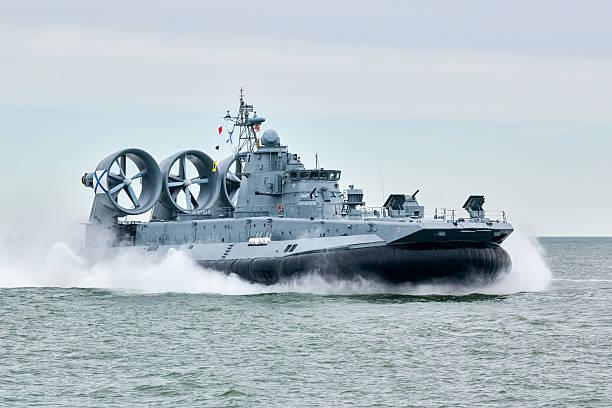 istock Hovercraft warship armed with armament sails into sea toward military target to attack and destroy 2206875153