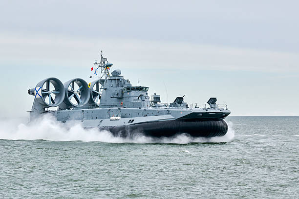 istock Hovercraft warship armed with armament sails into sea toward military target to attack and destroy 2206875162