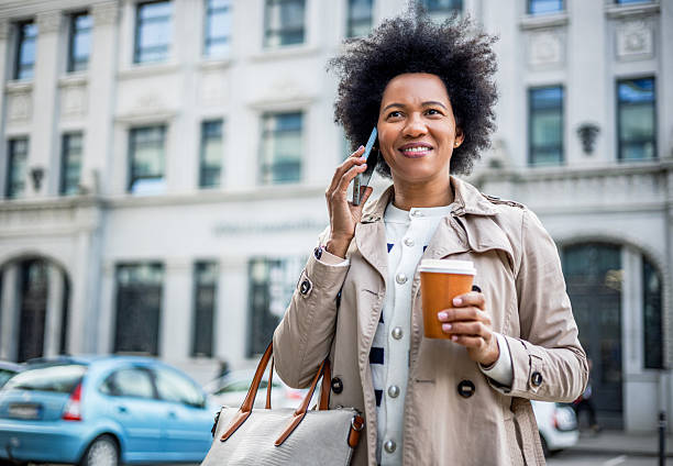 istock Woman talking on the phone while walking in the city 2206875218