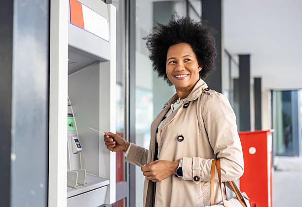 istock Young woman using an ATM 2206875534