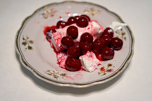 istock cottage cheese with cherries stands on the kitchen table, dessert 2206875992