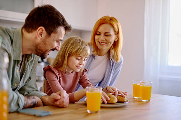 istock Happy family having breakfast in the kitchen 2206876308