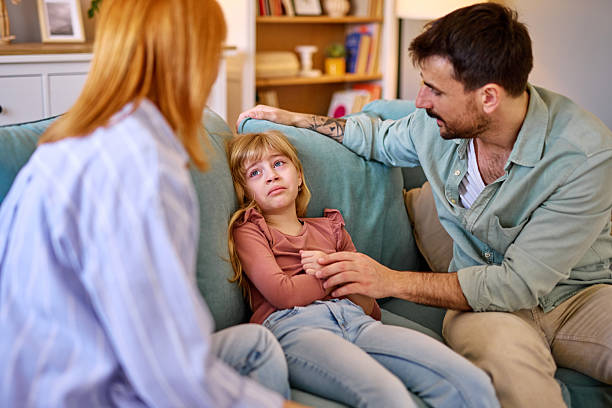 istock Parents comforting their sad daughter at home 2206876482