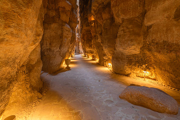 Illuminated pathway winding through Jabal Al Qarah caves in Saudi Arabia