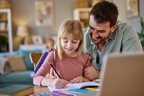 istock Father and daughter drawing together at home 2206877121
