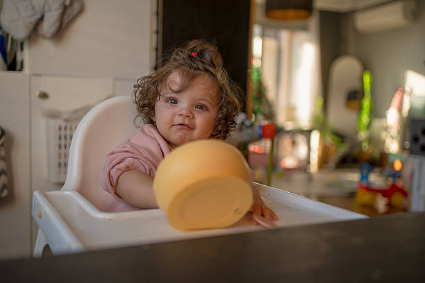 istock Curious Baby Girl Playing with Her Bowl 2206877545