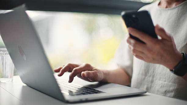 istock Mature woman using laptop and smartphone. 2206877832