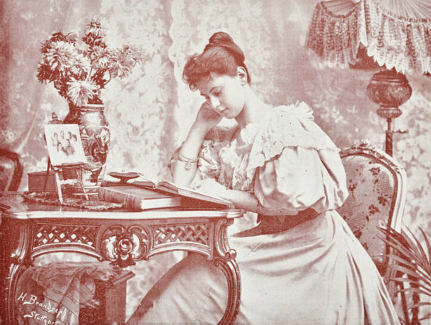 istock Book reading lady, sitting at a table filled with books, flowers and images 2206878413