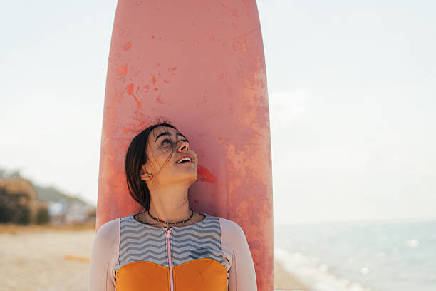 istock Surfer girl and her surfboard 2206879229