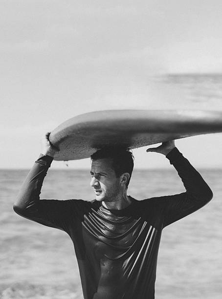 Malibu, California - June 6, 2023 - Image capturing candid, high-energy surfing action in dynamic coastal settings, highlighting surfers' athletic skill, surf culture, and the vibrant energy of the ocean and beach lifestyle.