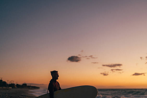 Woman waiting for sunrise over ocean, background with copy space, Queensland, full frame horizontal composition
