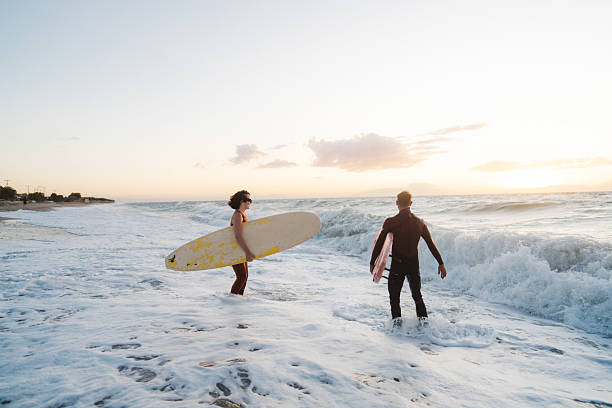 istock Couple of surfers 2206879780