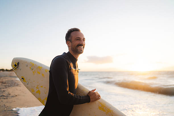 istock Male surfer holding his surfboard at the beach 2206879841