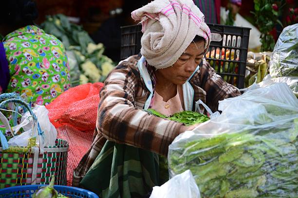 BAGAN, Myanmar – December 09, 2016: A vendor at a bustling marketplace in Bagan, Myanmar, showcasing local goods.