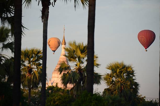 BAGAN, Myanmar – December 10, 2016: Hot air balloons soar over Bagan, Myanmar, during a stunning sunset.