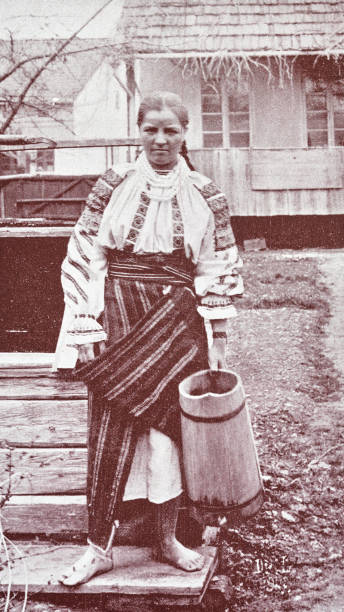 istock Romania, Bukovina, young maid outdoors holding a wooden jug 2206880070