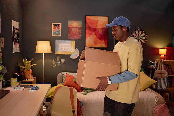 istock Person Holding Moving Boxes in Stylish Room Setting 2206880503