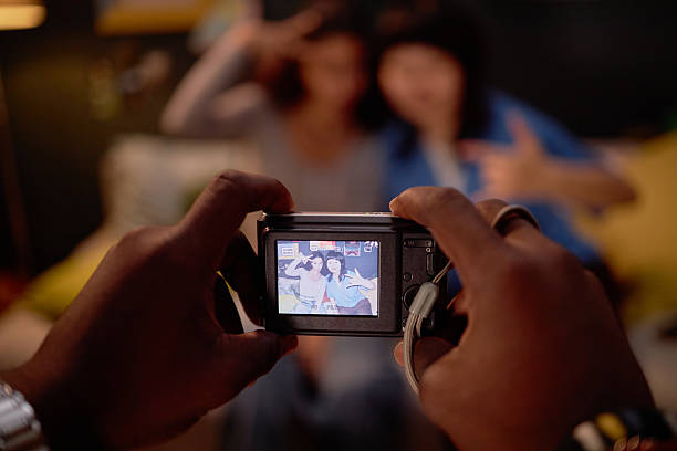 istock Photographing Friends Posing for Camera Inside A Room 2206880507