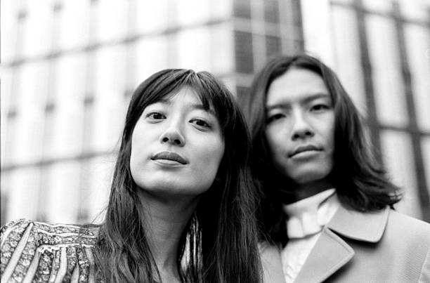 istock Two young creative professionals posing in urban setting, grainy black and white analog film look 2206884156