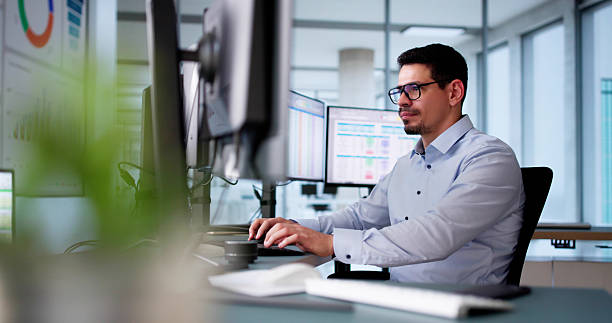 istock Male In The Office Audits Medical Billing Reports. 2206884991