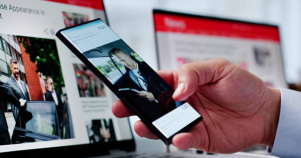 istock Watching Online News Article On Mobile Phone And Laptop 2206885133