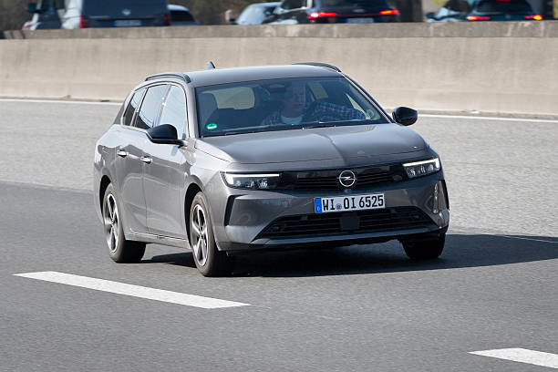 Diedenbergen, Germany - March 20, 2025: A grey Opel Astra Sports Tourer on a highway nearby Wiesbaden, Germany. The Opel Astra is a compact car/small family car developed and produced by Adam Opel since 1991, currently at its sixth generation. Opel is a subsidiary of General Motors