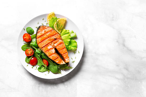 istock Grilled Salmon fish steak with green vegetable salad 2206886102