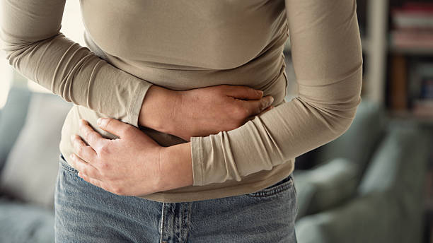 istock Young woman with stomach ache 2206886883
