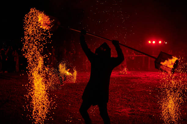 istock Silhouette of Two Fire Performers Creating Sparks Against Night field 2206887340